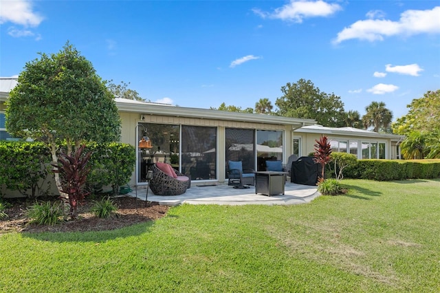 back of property featuring a lawn and a patio area