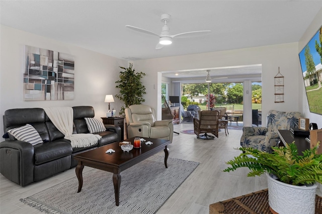 living room with ceiling fan and light hardwood / wood-style floors