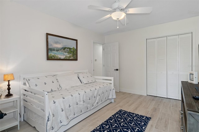 bedroom with a closet, ceiling fan, and light hardwood / wood-style flooring