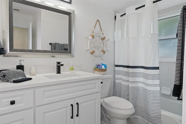 full bathroom featuring toilet, shower / bath combo with shower curtain, and vanity