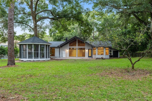 exterior space with a front yard and a sunroom