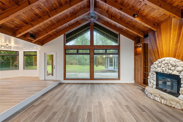 unfurnished living room featuring a fireplace, light hardwood / wood-style floors, and wooden ceiling