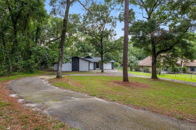 view of front of house with a garage and a front lawn