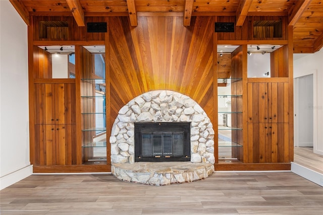 unfurnished living room featuring wood walls, wood ceiling, and a fireplace