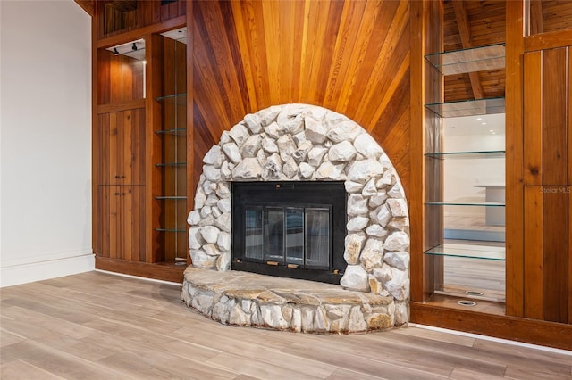 interior details featuring wood ceiling, wood-type flooring, and a fireplace