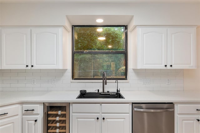 kitchen with sink, tasteful backsplash, dishwasher, white cabinetry, and beverage cooler