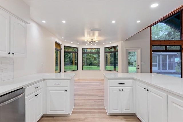 kitchen featuring dishwasher, tasteful backsplash, light wood-type flooring, white cabinets, and kitchen peninsula