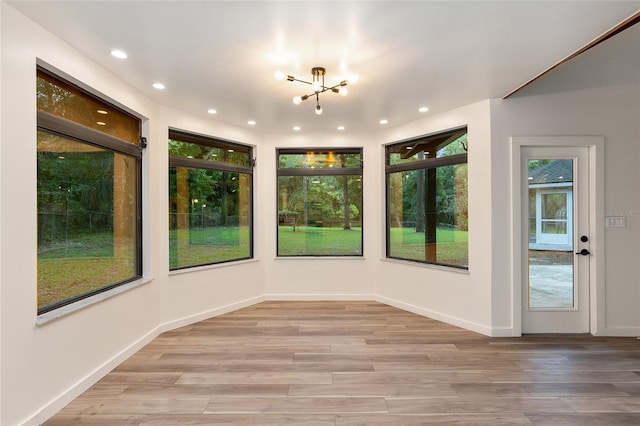 interior space featuring hardwood / wood-style flooring and a chandelier