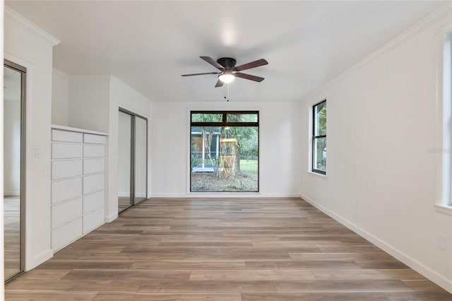 unfurnished room featuring ceiling fan, ornamental molding, and hardwood / wood-style flooring