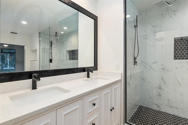 bathroom with an enclosed shower and double vanity