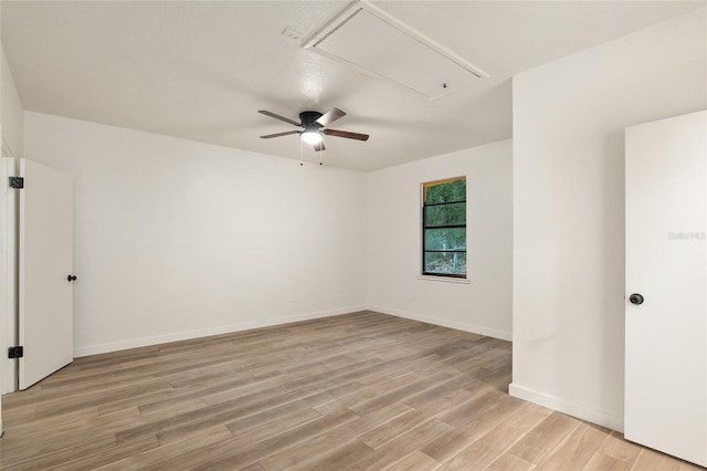 spare room featuring ceiling fan and light hardwood / wood-style floors