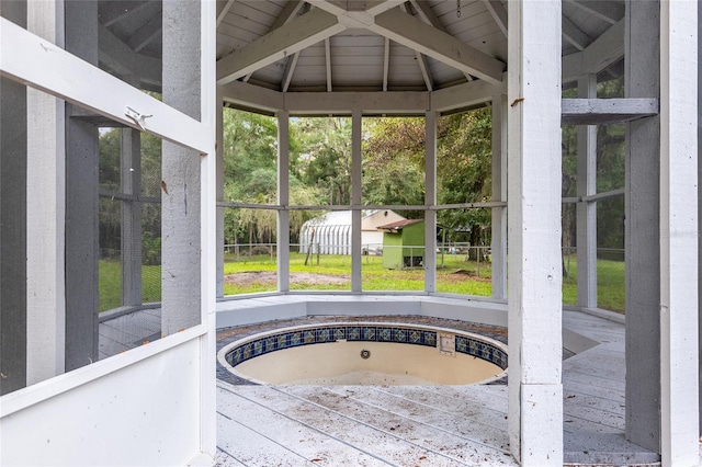 unfurnished sunroom with lofted ceiling