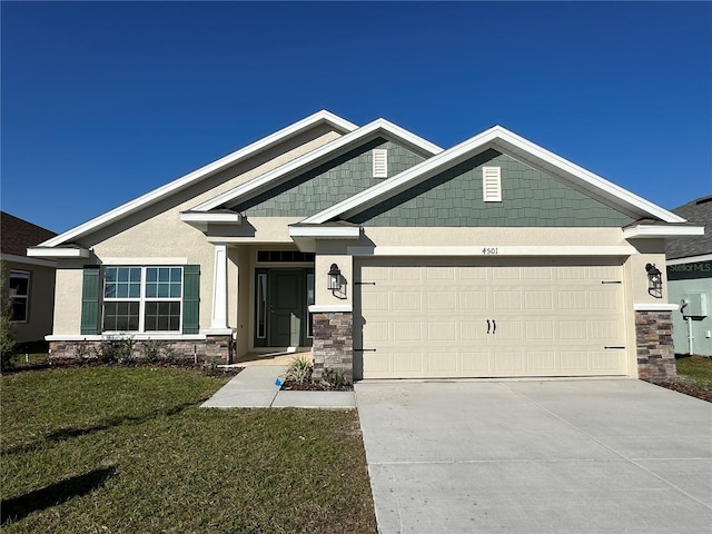 craftsman-style home with driveway, stone siding, stucco siding, an attached garage, and a front yard