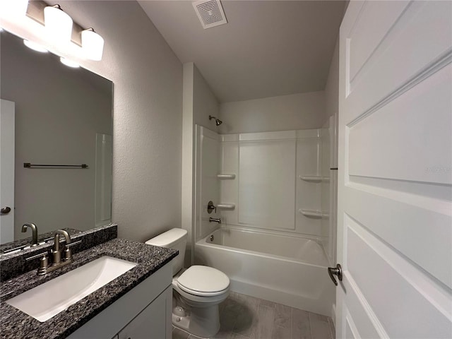 full bathroom with toilet, washtub / shower combination, visible vents, and vanity