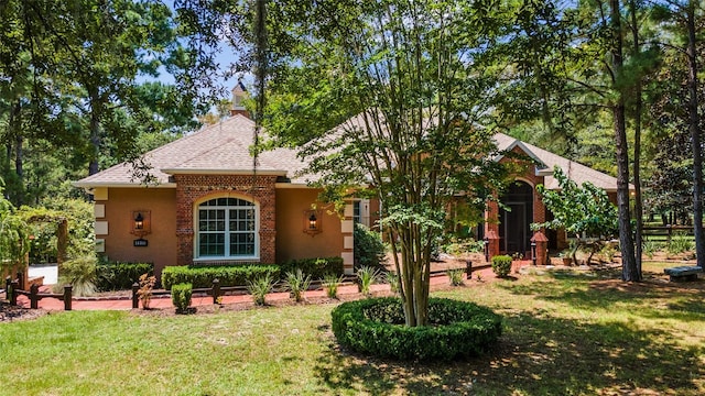 rear view of property with a lawn