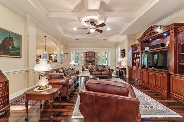 living room featuring ceiling fan, dark hardwood / wood-style flooring, crown molding, and coffered ceiling