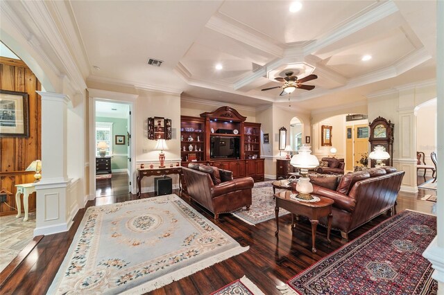 living room featuring ceiling fan, coffered ceiling, decorative columns, and dark wood-type flooring