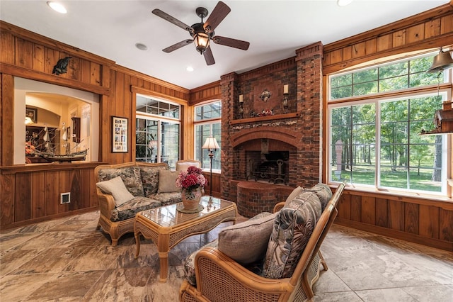 tiled living room with brick wall, wooden walls, and a healthy amount of sunlight