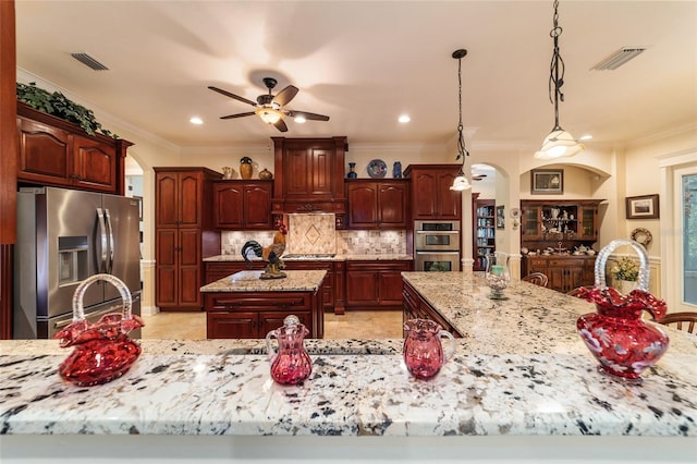 kitchen featuring backsplash, appliances with stainless steel finishes, ceiling fan, light tile patterned floors, and hanging light fixtures