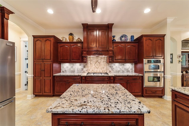 kitchen featuring backsplash, light tile patterned floors, light stone counters, and stainless steel appliances