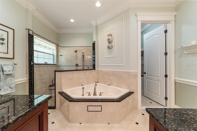 bathroom featuring tile patterned flooring, tiled tub, ornamental molding, and vanity