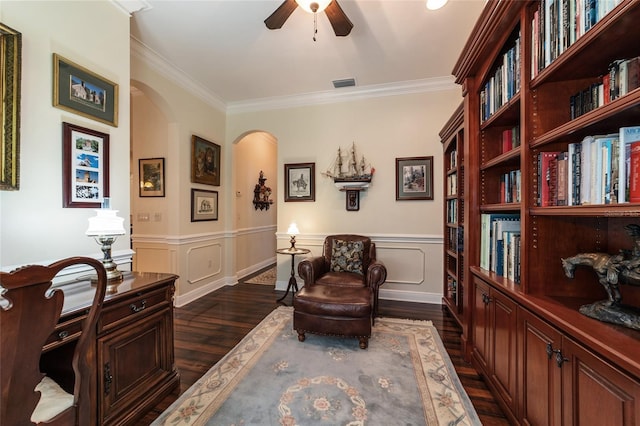 sitting room featuring dark hardwood / wood-style flooring, ceiling fan, and ornamental molding