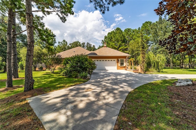 view of front of home featuring a garage and a front lawn