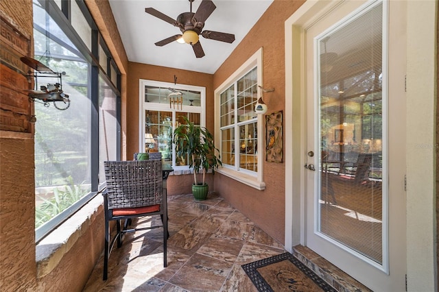 sunroom featuring ceiling fan