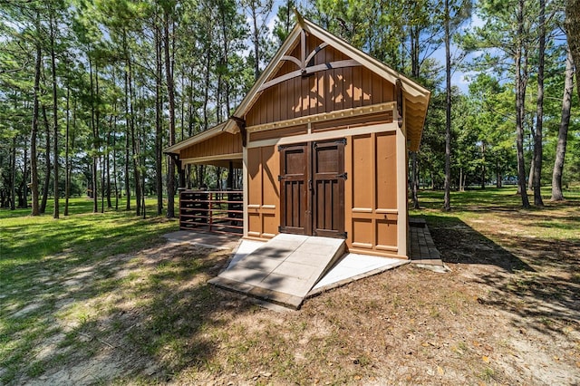 view of outbuilding featuring a lawn