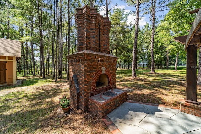 view of patio / terrace featuring an outdoor brick fireplace