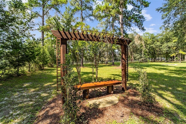 view of community with a pergola and a yard