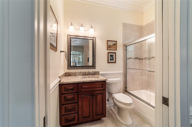 full bathroom with toilet, bath / shower combo with glass door, tile patterned flooring, vanity, and ornamental molding