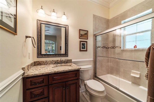 full bathroom with toilet, crown molding, vanity, and enclosed tub / shower combo