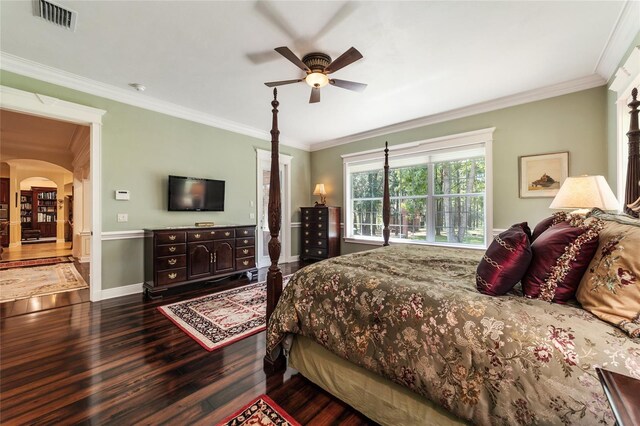 bedroom with hardwood / wood-style flooring, ornamental molding, and ceiling fan