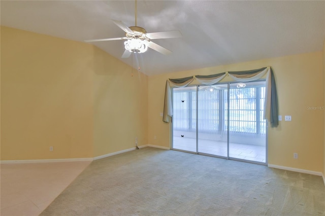 carpeted spare room featuring lofted ceiling and ceiling fan