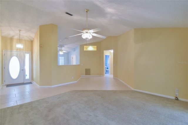 carpeted foyer featuring a textured ceiling, ceiling fan with notable chandelier, and vaulted ceiling