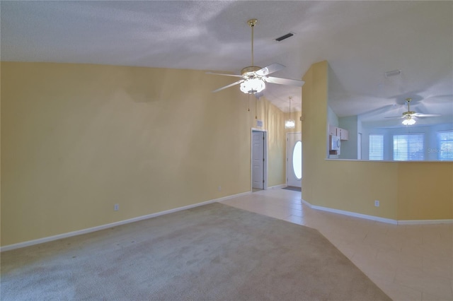 unfurnished room featuring vaulted ceiling, ceiling fan, and light colored carpet