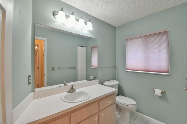 bathroom featuring a textured ceiling, vanity, toilet, and tile patterned floors