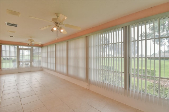 unfurnished sunroom with a wealth of natural light and ceiling fan