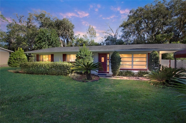 ranch-style home featuring a yard