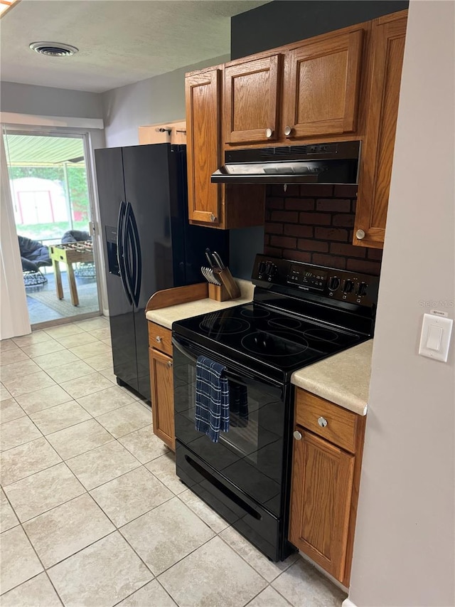 kitchen featuring light tile patterned floors and black electric range