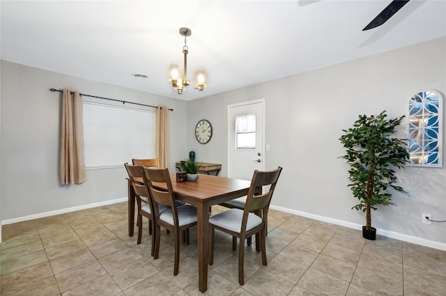 tiled dining space with a notable chandelier