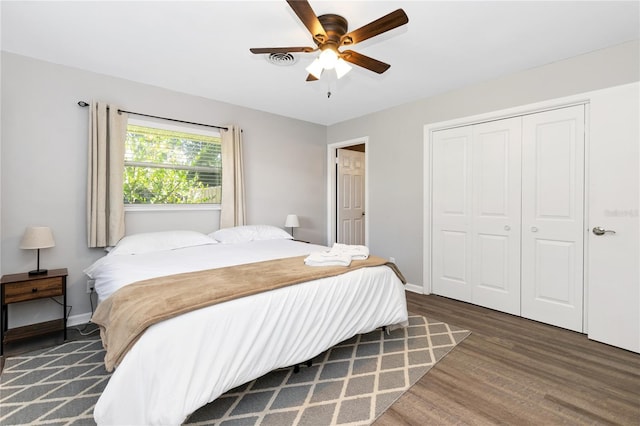 bedroom featuring a closet, ceiling fan, and dark hardwood / wood-style flooring