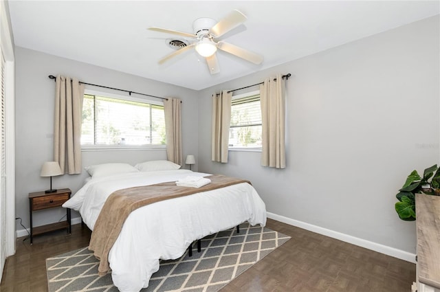 bedroom featuring ceiling fan and dark parquet flooring