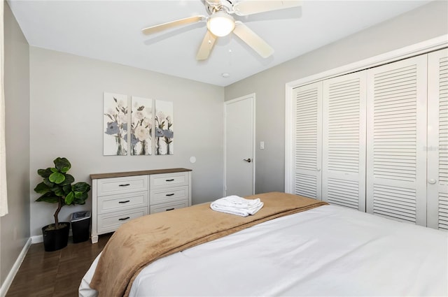 bedroom with ceiling fan, a closet, and dark wood-type flooring