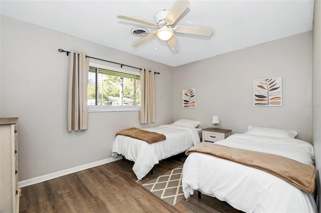 bedroom with ceiling fan and dark hardwood / wood-style flooring