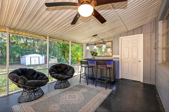 sunroom / solarium featuring ceiling fan and vaulted ceiling