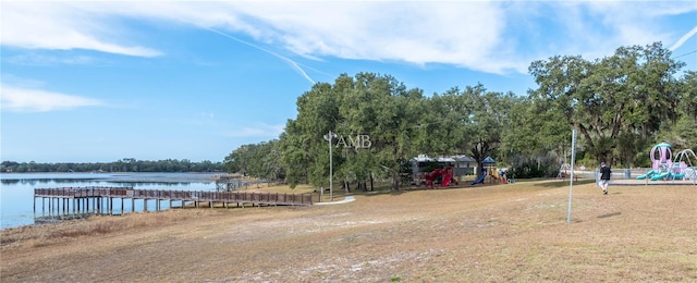 exterior space featuring playground community and a water view