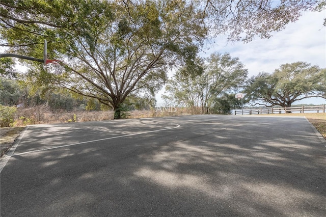 exterior space featuring community basketball court and fence