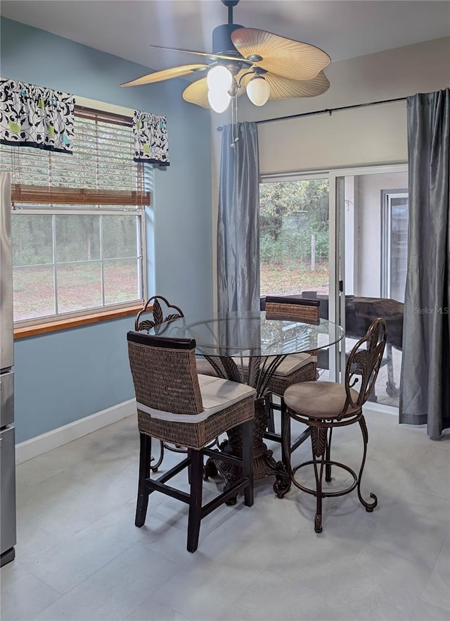 dining space featuring baseboards and a ceiling fan